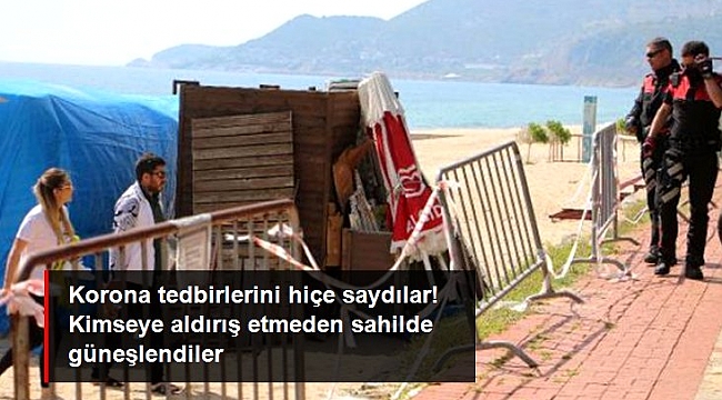 Sahilde güneşlenirken polise yakalanan 3 kişiye para cezası uygulandı.