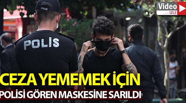 Polisi gören maskesine sarıldı.