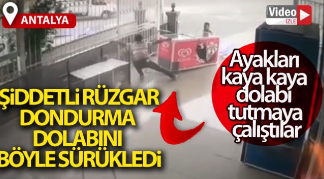 Şiddetli rüzgar dondurma dolabını sürükledi, ayakları kaya kaya dolabı tutmaya çalıştılar