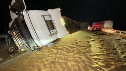 Tır devrildi, saçılan hayvan yemi yolu kapattı